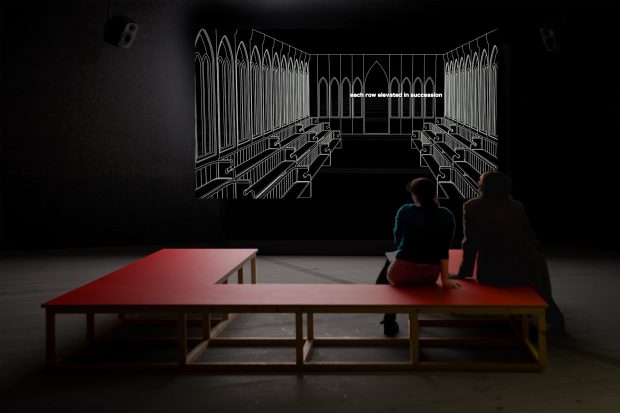 Image of Elizabeth Price's work 'CHOIR' installed in the BALTIC gallery, two people seated on a red U-shaped bench are watching a projected image which shows the interior of a church 'choir' is shown as a white line drawing on a black background.
